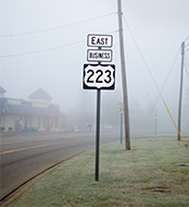 Road sign in foggy surrounding (photo)